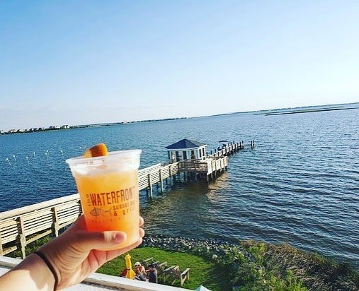 frozen cocktail being held with lake in the background